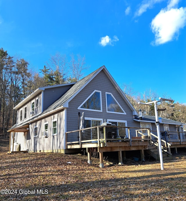 rear view of house with a wooden deck