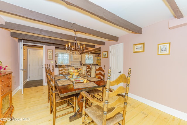 dining room with beam ceiling, light hardwood / wood-style flooring, and a chandelier