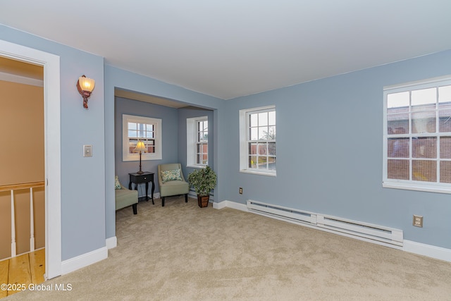 unfurnished room with light carpet and baseboard heating