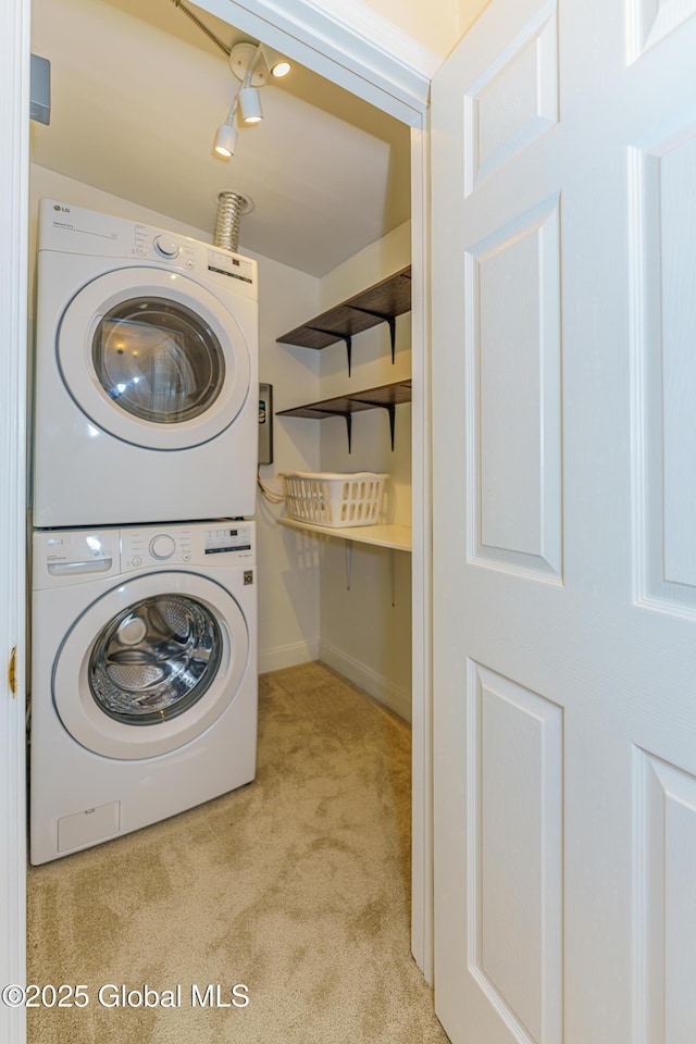 laundry room featuring light carpet and stacked washer and clothes dryer