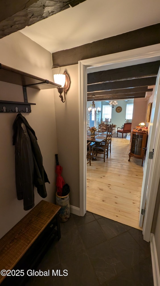 mudroom featuring beamed ceiling, a chandelier, and dark hardwood / wood-style floors