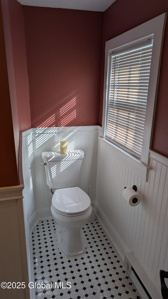 bathroom with tile patterned floors, a baseboard radiator, and toilet