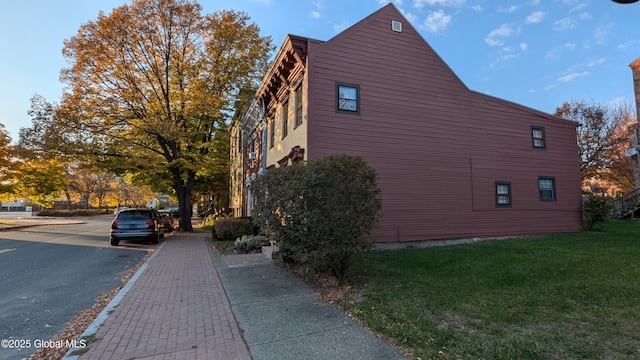 view of side of home with a lawn