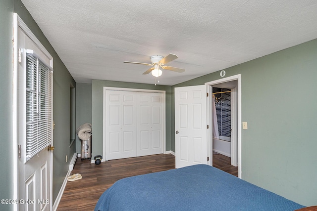 bedroom with a textured ceiling, a closet, ceiling fan, and dark hardwood / wood-style floors