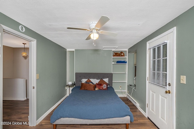 bedroom featuring a textured ceiling, dark hardwood / wood-style floors, a baseboard radiator, and ceiling fan