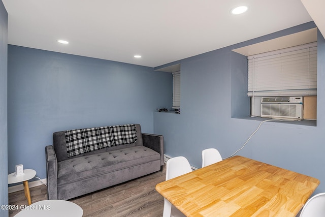 dining space featuring cooling unit and wood-type flooring