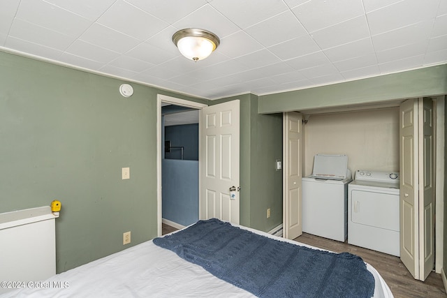 bedroom featuring hardwood / wood-style flooring and washing machine and clothes dryer