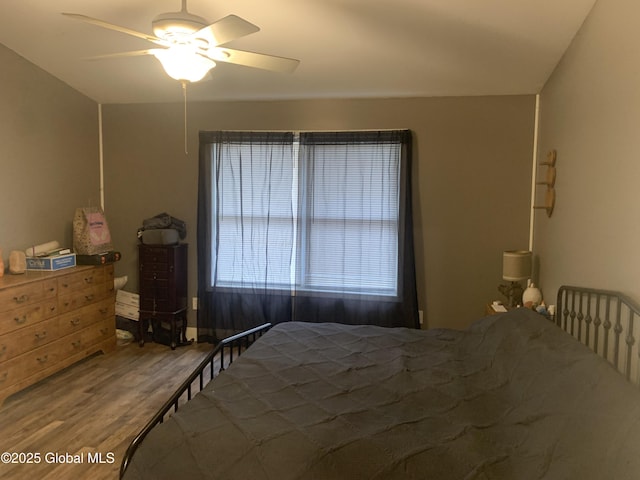 bedroom featuring ceiling fan and dark wood-type flooring