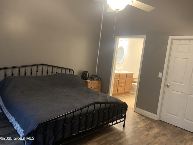 bedroom with ensuite bathroom, ceiling fan, and hardwood / wood-style flooring