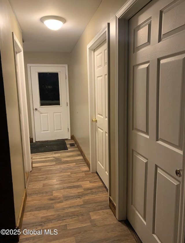 hallway with dark hardwood / wood-style flooring