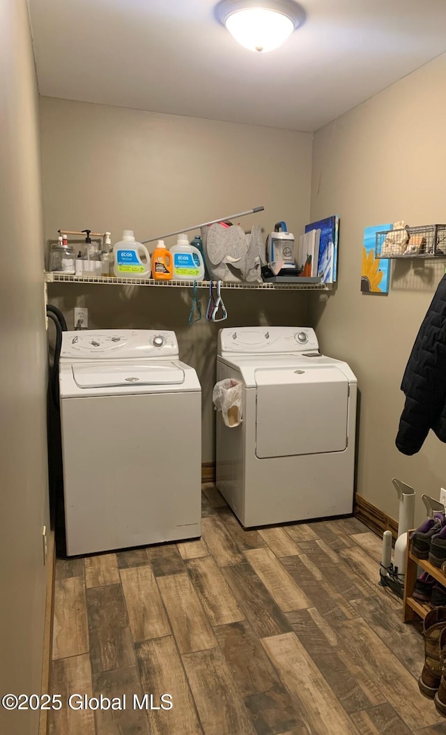 laundry room featuring dark hardwood / wood-style floors and washer and clothes dryer