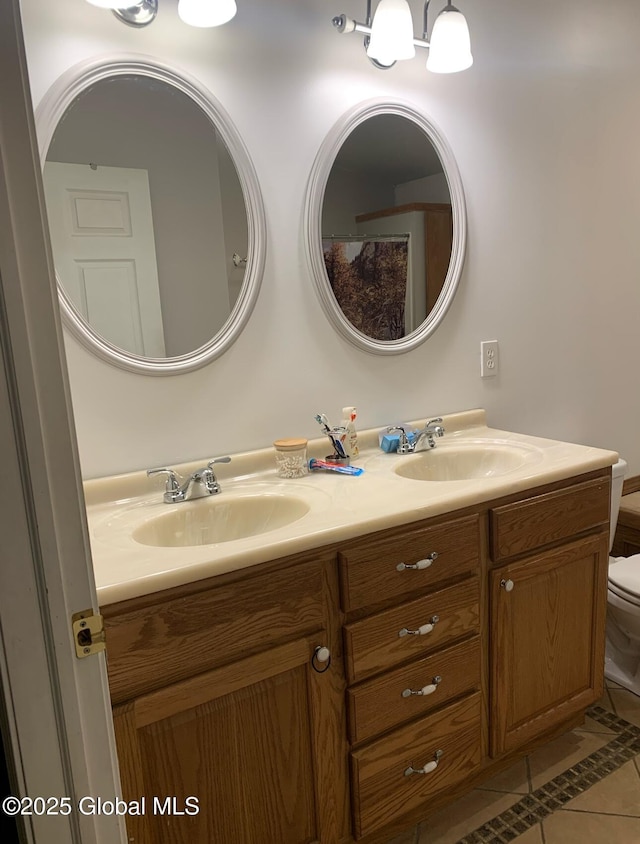 bathroom with tile patterned floors, vanity, and toilet