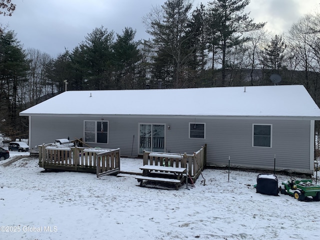 view of snow covered back of property