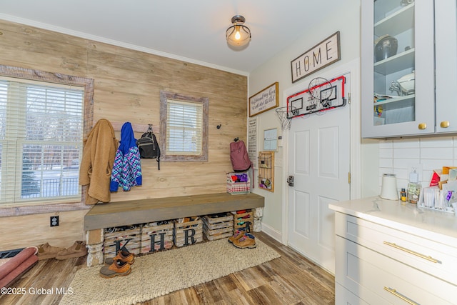 mudroom with wood walls and wood finished floors