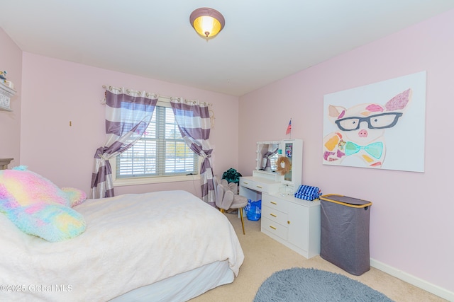 bedroom featuring light colored carpet and baseboards