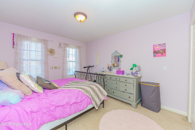 bedroom featuring light colored carpet and baseboards