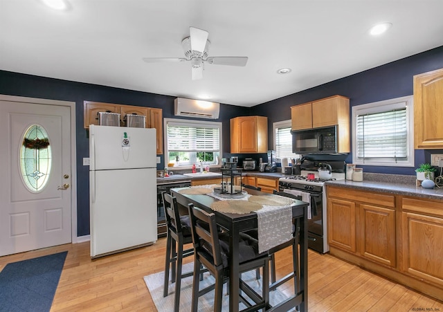 kitchen with light hardwood / wood-style flooring, dishwasher, gas range, ceiling fan, and white refrigerator