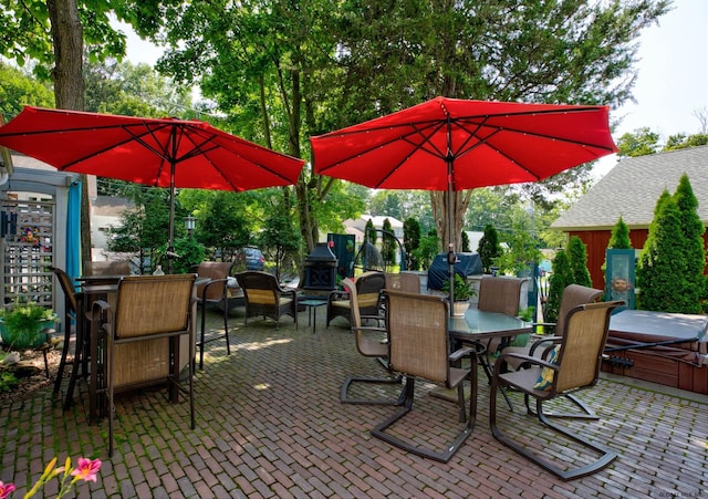 view of patio / terrace with a hot tub and grilling area