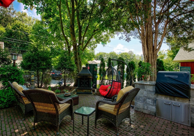 view of patio with exterior kitchen, exterior fireplace, and grilling area