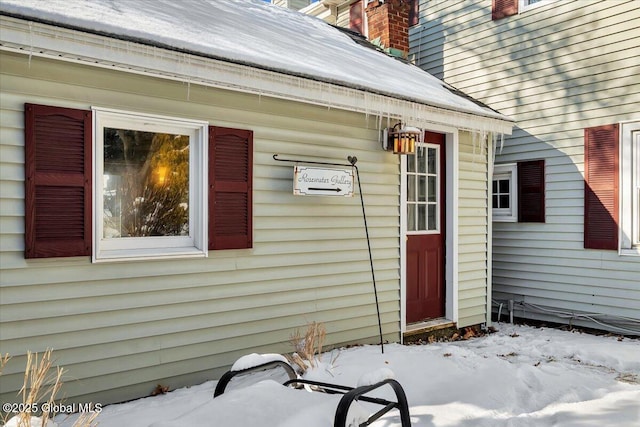 view of snow covered property entrance