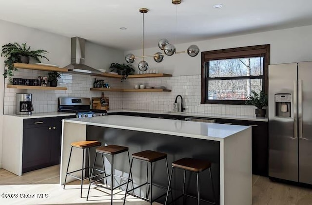 kitchen featuring backsplash, sink, wall chimney exhaust hood, and appliances with stainless steel finishes