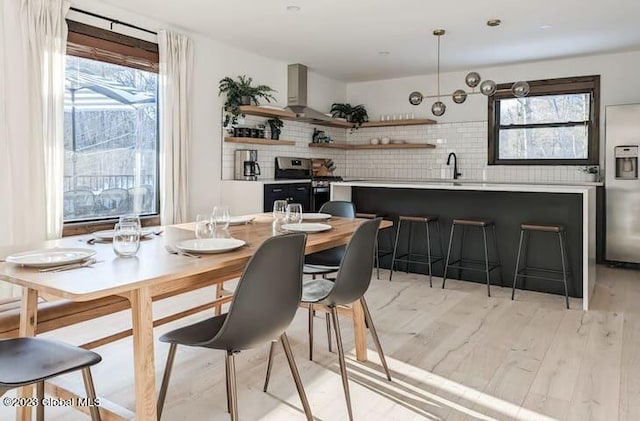 dining space with light hardwood / wood-style floors