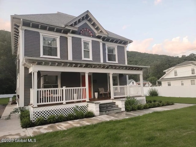 view of front facade with a porch and a yard