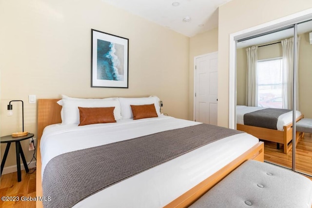 bedroom with a closet and hardwood / wood-style flooring