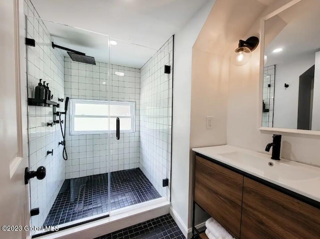 bathroom with vanity, tile patterned floors, and a shower with door