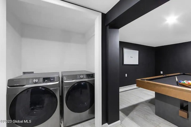 laundry room with washing machine and dryer, light hardwood / wood-style floors, a baseboard radiator, and billiards