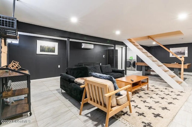 living room featuring a wall mounted air conditioner and washing machine and clothes dryer