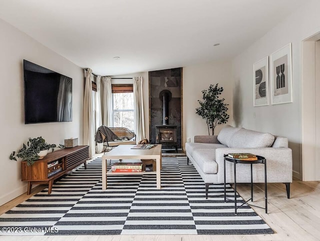 living room featuring hardwood / wood-style flooring and a wood stove