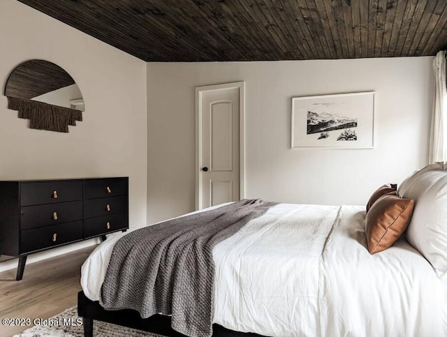 bedroom with hardwood / wood-style floors, wood ceiling, and lofted ceiling