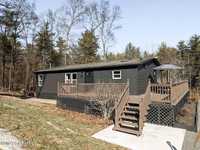 back of house featuring a yard and a wooden deck