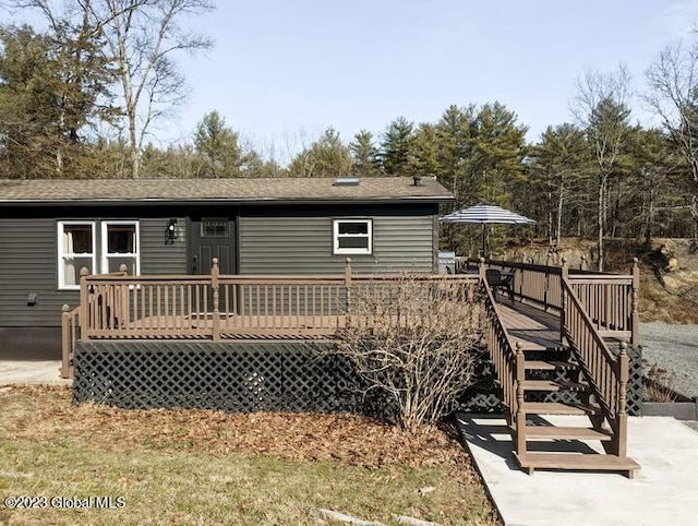 back of house featuring a wooden deck