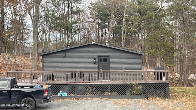 view of side of home with a wooden deck