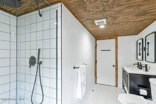 bathroom with vanity, toilet, wood ceiling, and a tile shower