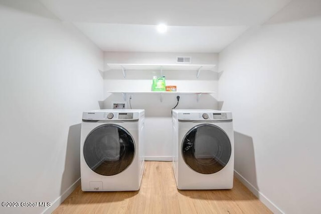 washroom featuring light wood-type flooring and separate washer and dryer