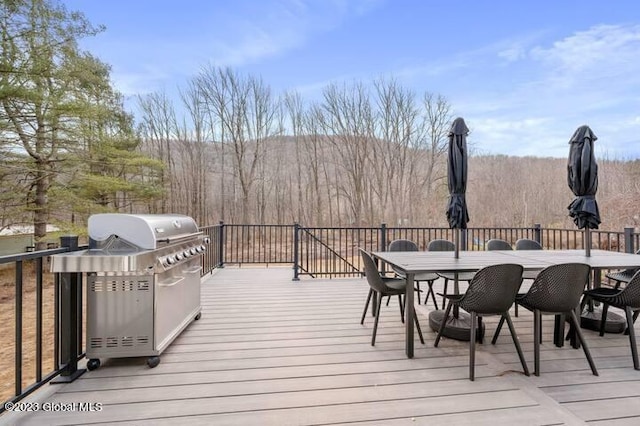 wooden deck featuring a grill