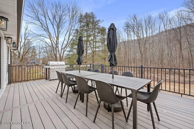 wooden deck featuring a grill