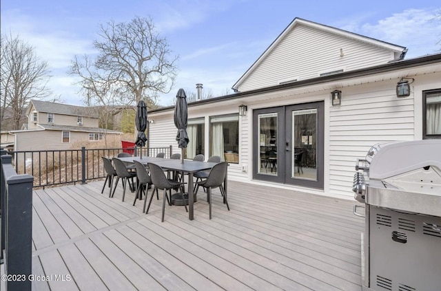 deck featuring french doors and a grill