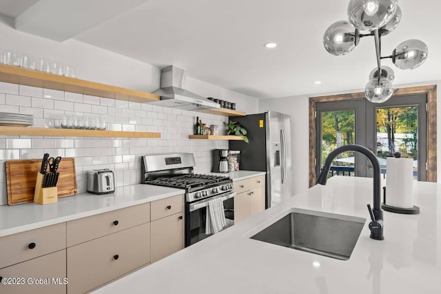 7913 Main St, Hunter, NY 12442 - kitchen featuring french doors, wall chimney range hood, sink, appliances with stainless steel finishes, and tasteful backsplash