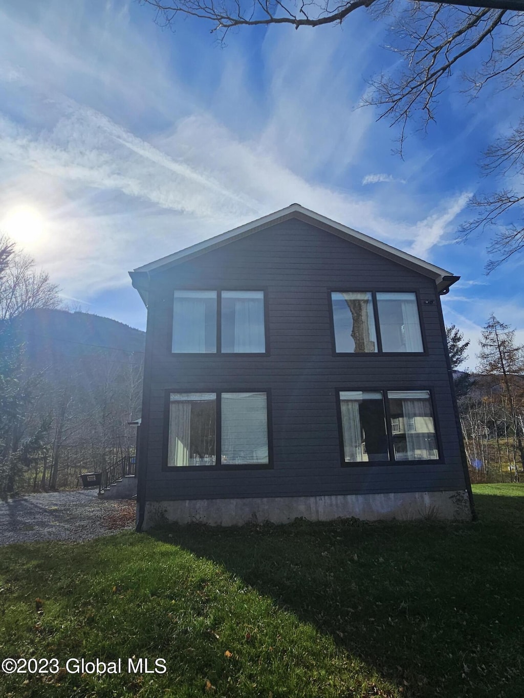 view of home's exterior featuring a mountain view and a yard