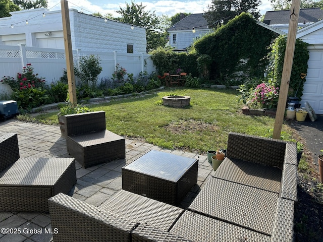 exterior space with a fire pit, a fenced backyard, and a patio area