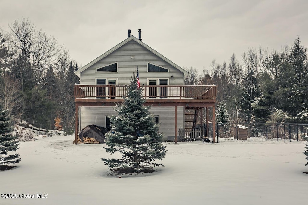 snow covered property with a wooden deck