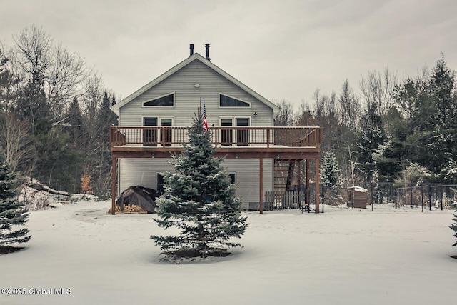 snow covered property with a wooden deck