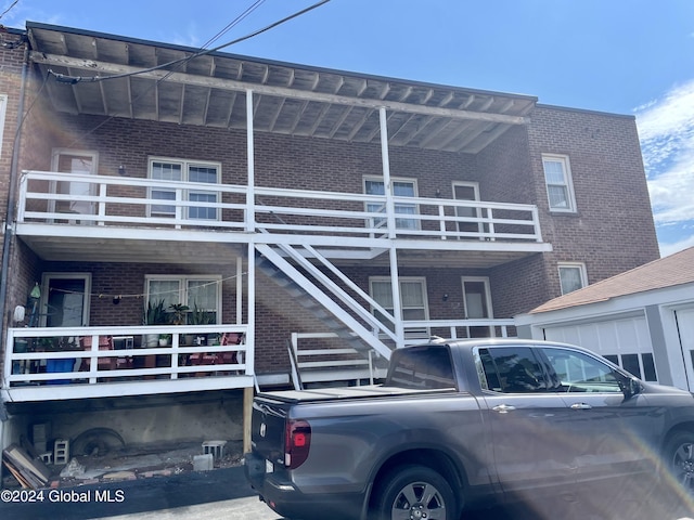 rear view of property with a balcony