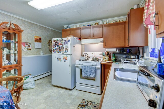 292 N Main St, Northville, NY 12134 - kitchen with white appliances, under cabinet range hood, baseboard heating, ornamental molding, and light countertops