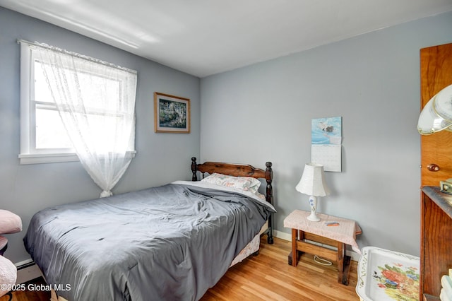 292 N Main St, Northville, NY 12134 - bedroom with wood finished floors and a baseboard heating unit