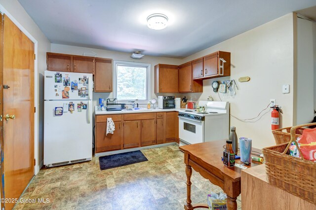 292 N Main St, Northville, NY 12134 - kitchen featuring white appliances, light countertops, a sink, and brown cabinetry